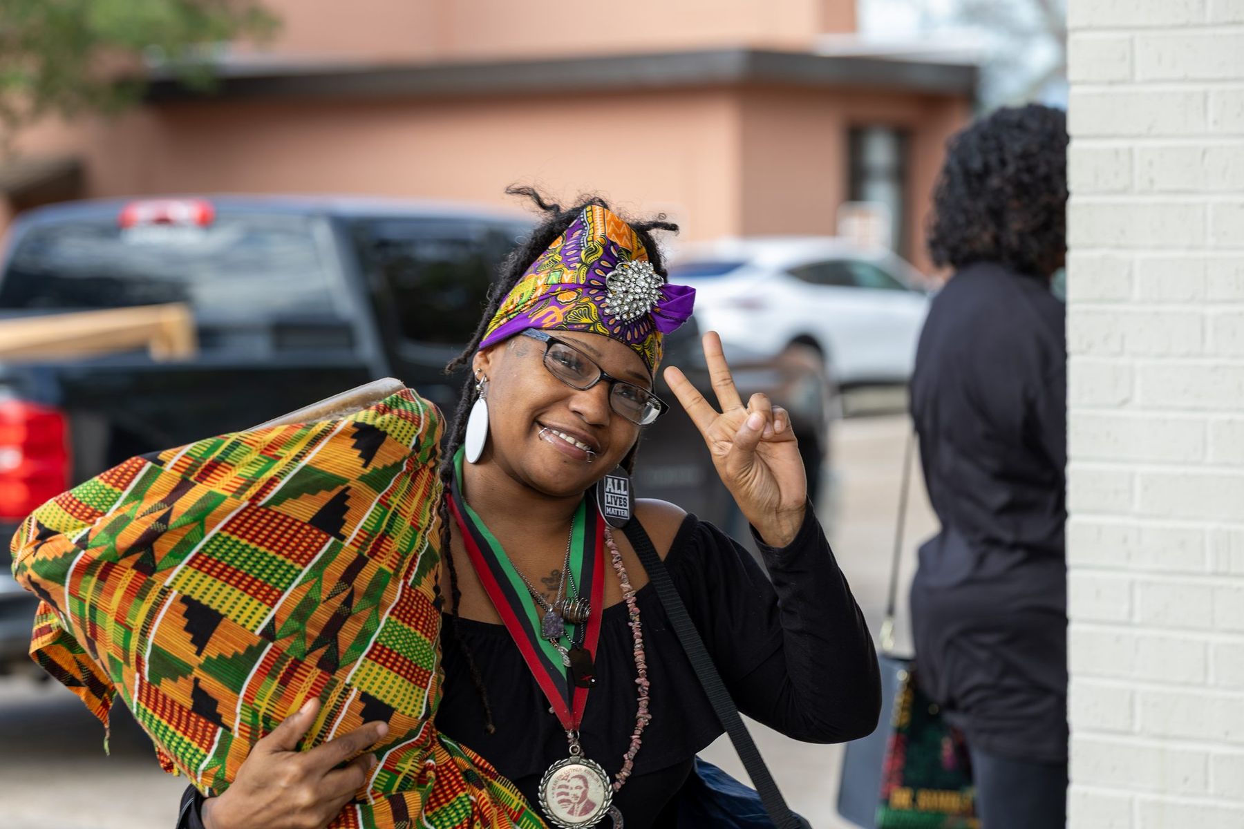 A woman draped in kente cloth