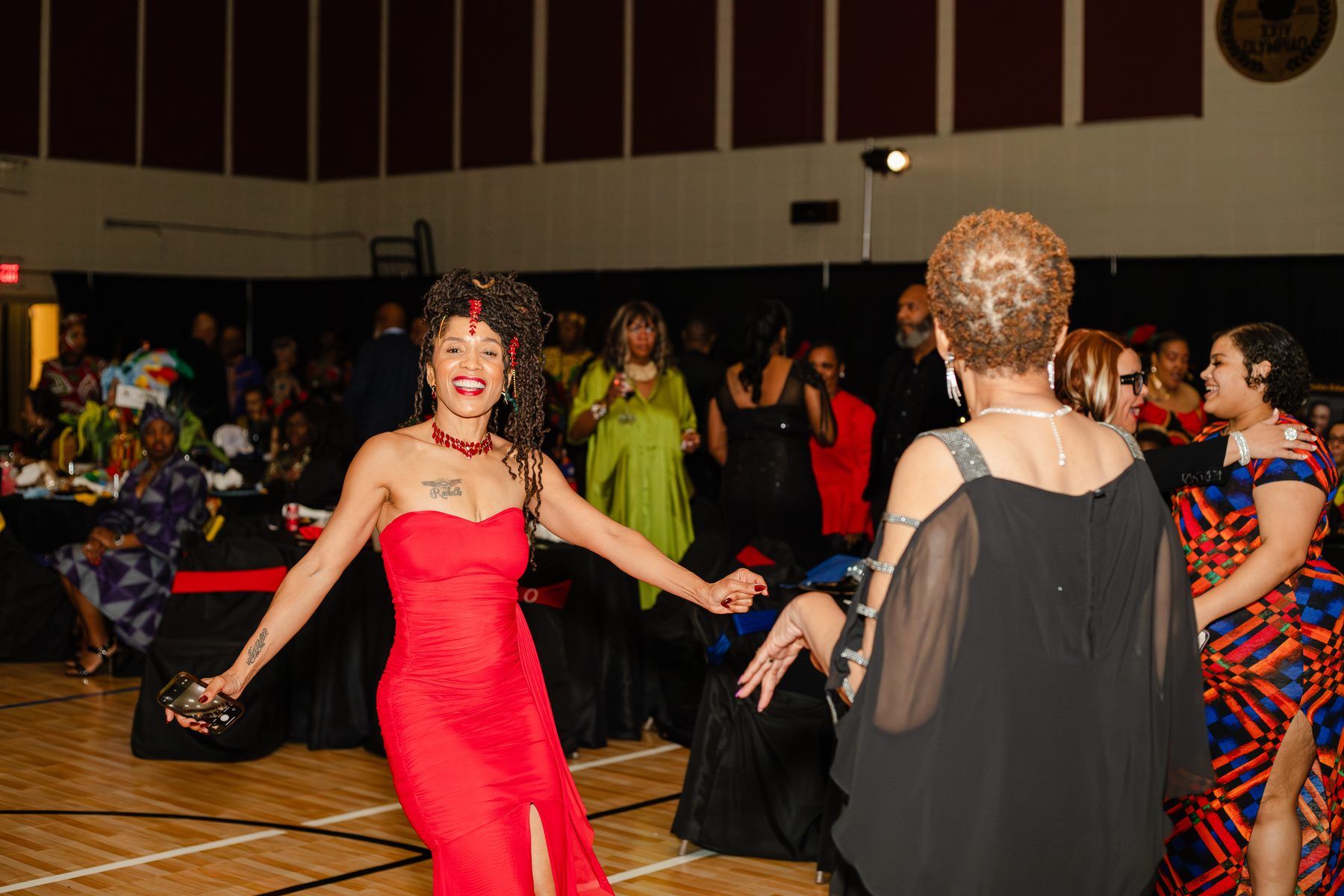 A guest in a red gown dancing
