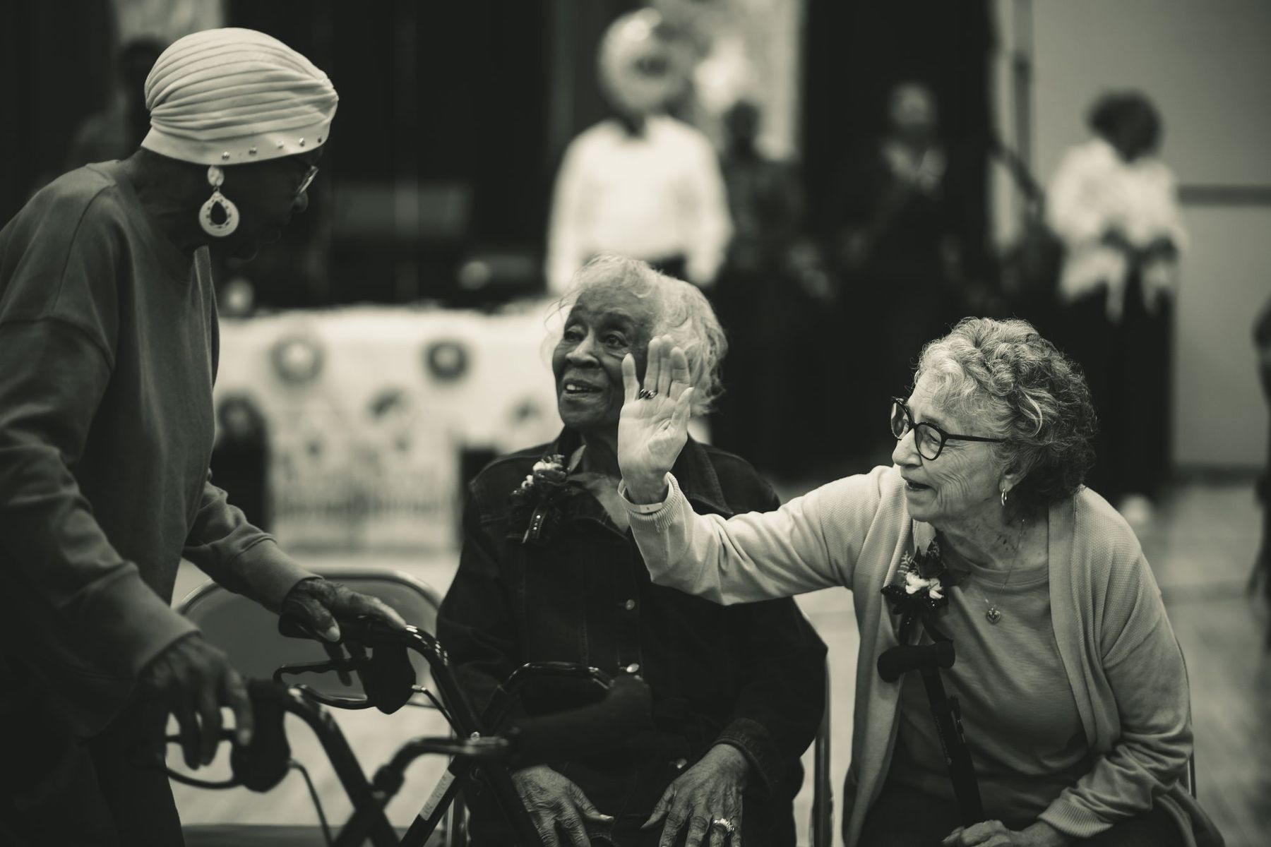 Elders greeting each other at their tables