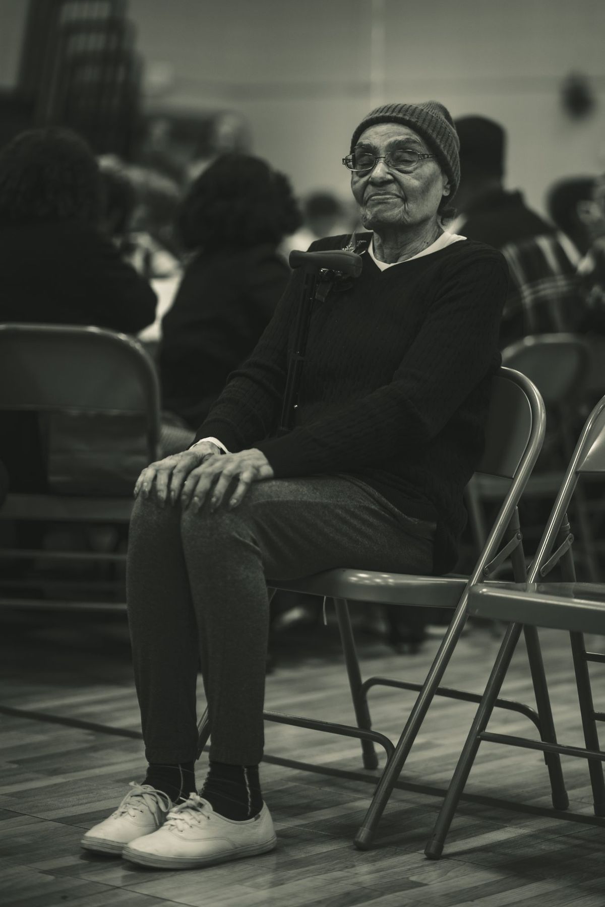 An elder seated, smiling
