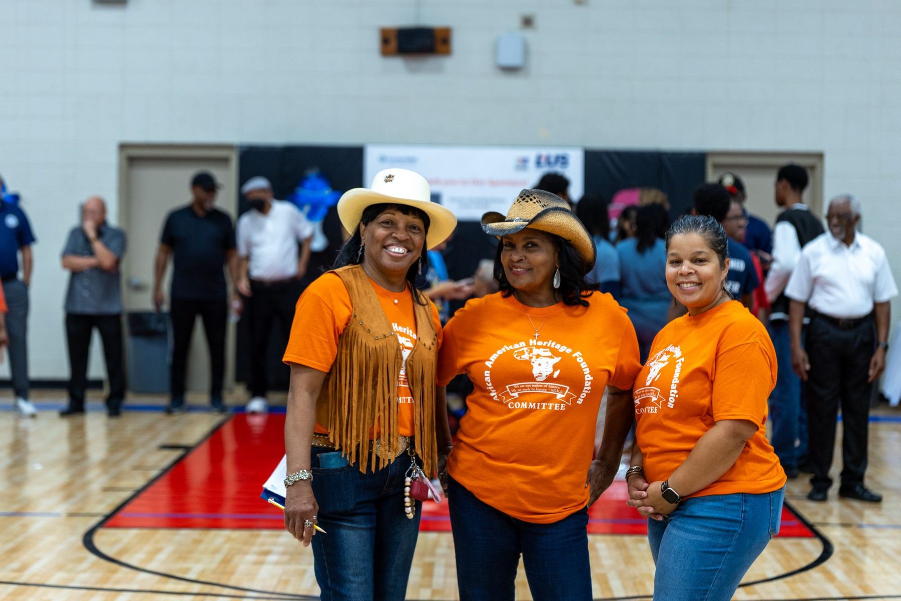 Foundation volunteers in orange shirts and western hats